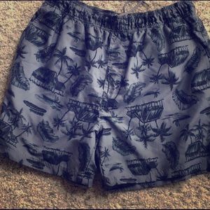 Gray and black tropical print swim trunks